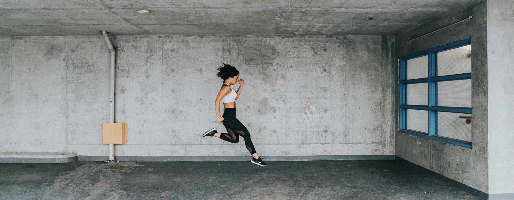 exercising woman caught jumping in mid-air