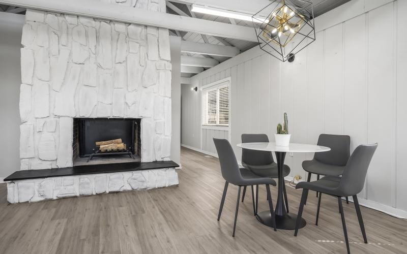 clubhouse with table, chairs and a fireplace